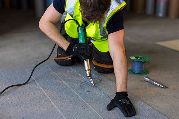 Staff member laying flooring
