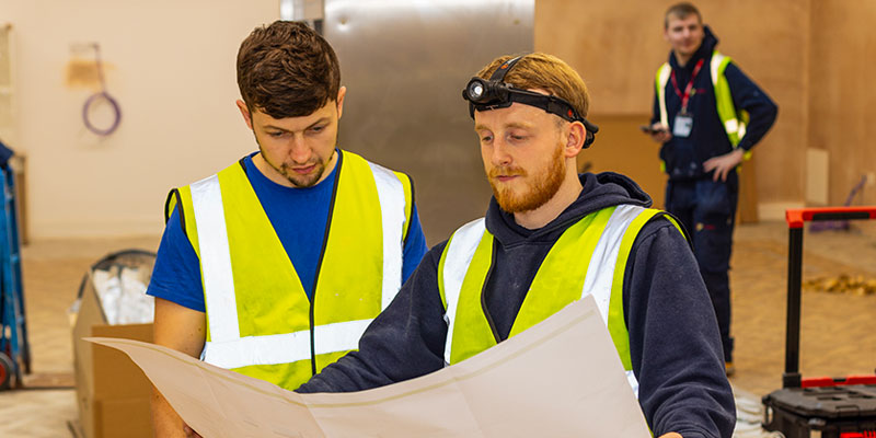 Crown Facilities staff looking at plans